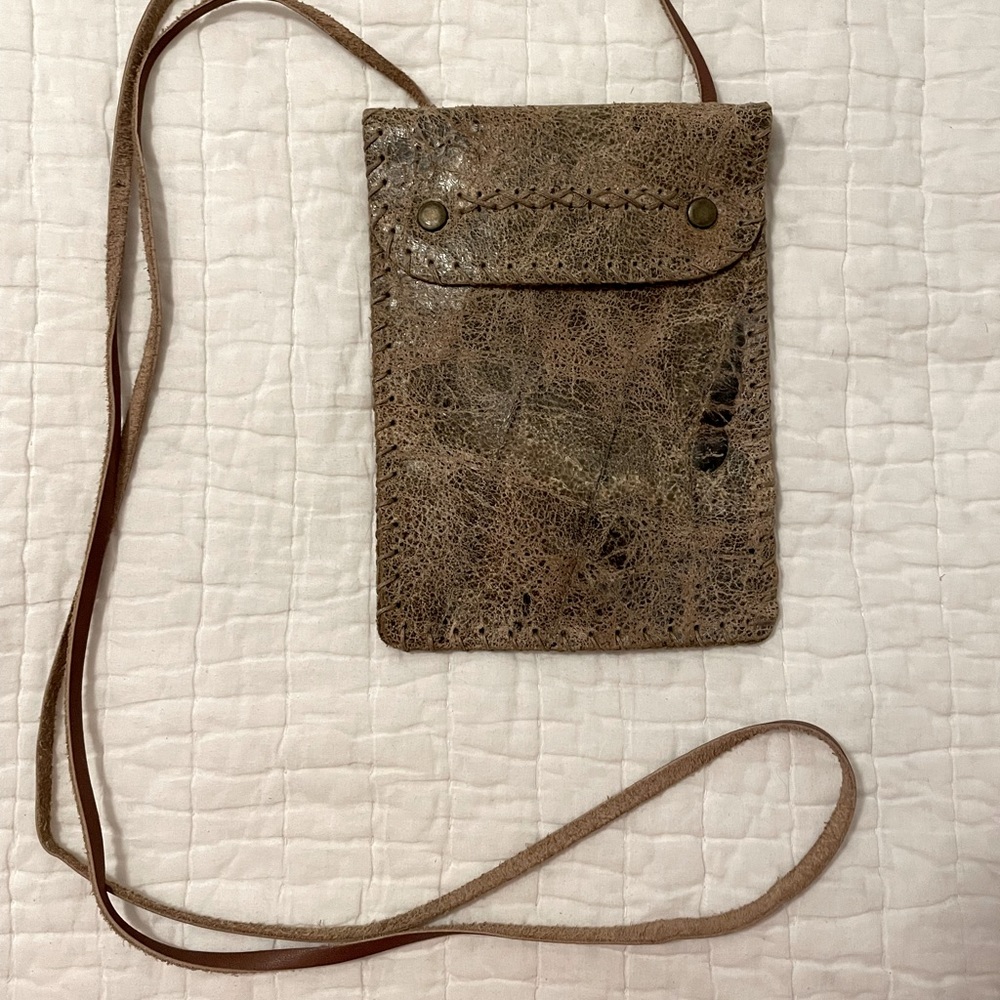 Leather crossbody with snap closure.